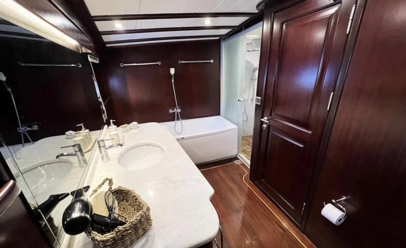 a bathroom with a sink and bathtub aboard ALWAYS SMILE Yacht for Charter