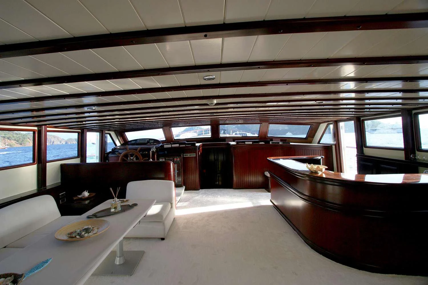 a room with tables and chairs aboard ALWAYS SMILE Yacht for Charter