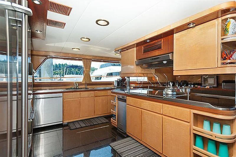 a kitchen with wooden cabinets aboard ALL OF ME Yacht for Sale