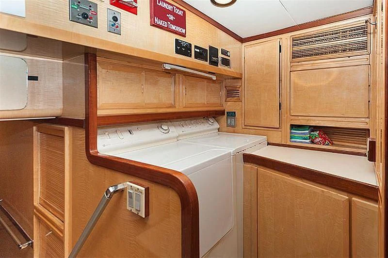 a kitchen with wooden cabinets aboard ALL OF ME Yacht for Sale