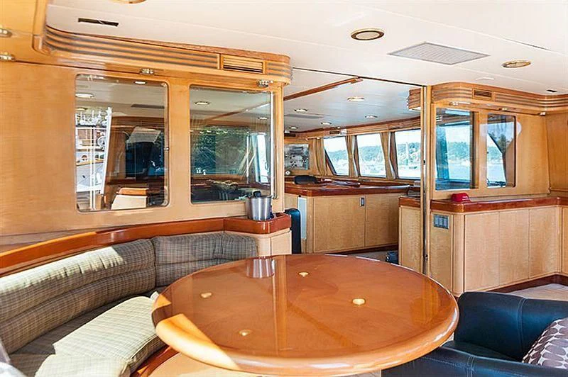 a cabin with a table and couch aboard ALL OF ME Yacht for Sale