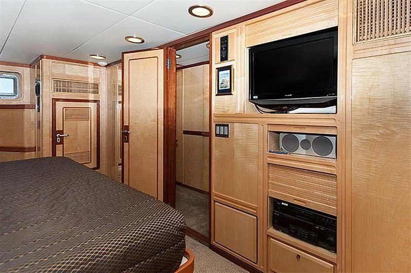 a bedroom with a tv and a bed aboard ALL OF ME Yacht for Sale