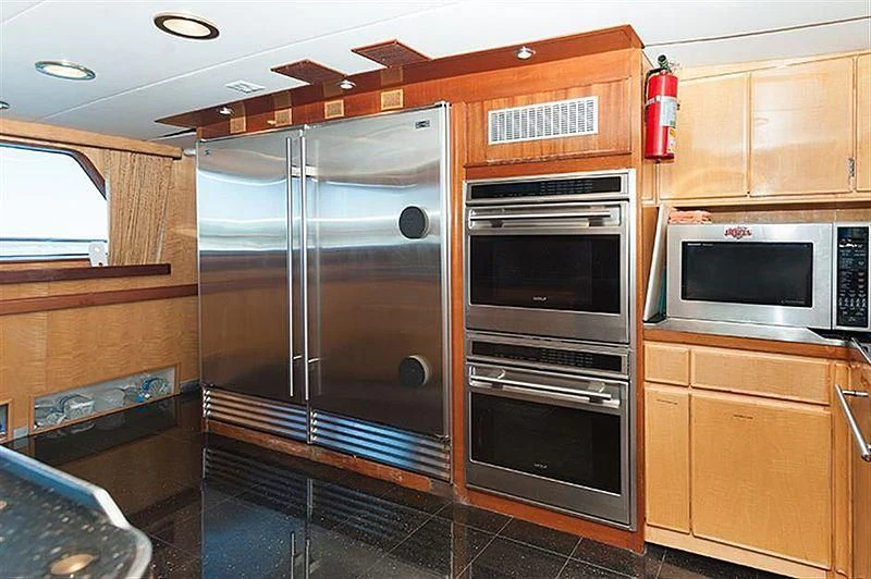 a kitchen with wooden cabinets aboard ALL OF ME Yacht for Sale