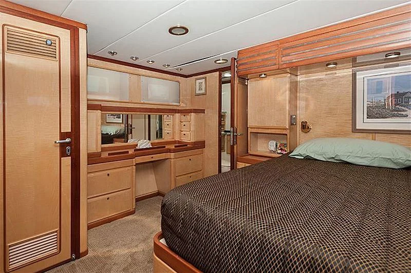 a bedroom with a bed and a desk aboard ALL OF ME Yacht for Sale