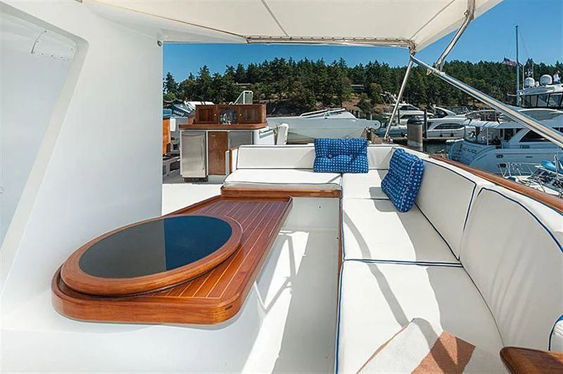 a patio with a pool and a deck with chairs and tables aboard ALL OF ME Yacht for Sale