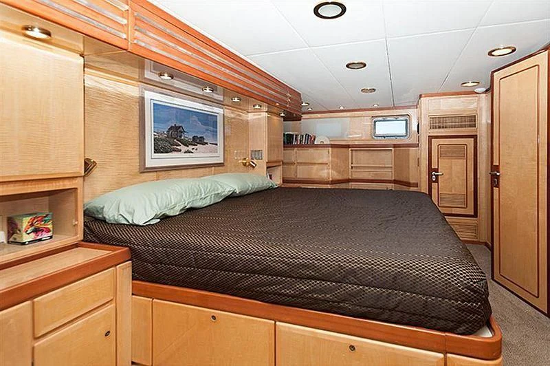 a bedroom with a bed and cabinets aboard ALL OF ME Yacht for Sale