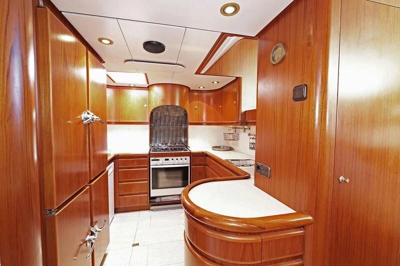 a kitchen with wooden cabinets aboard HIDE N SEA Yacht for Sale