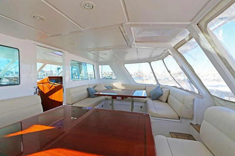 inside of a vehicle with a table and chairs and a bench aboard HIDE N SEA Yacht for Sale
