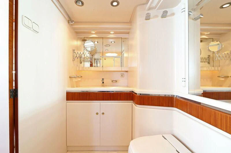 a bathroom with a tub sink and cabinets aboard HIDE N SEA Yacht for Sale