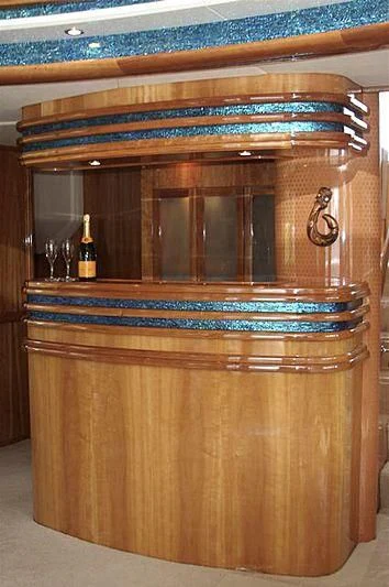 a wine bottle on a wooden cabinet aboard AZURE II Yacht for Sale