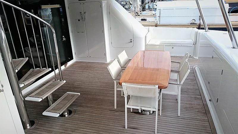 a room with a table and chairs aboard AZURE II Yacht for Sale