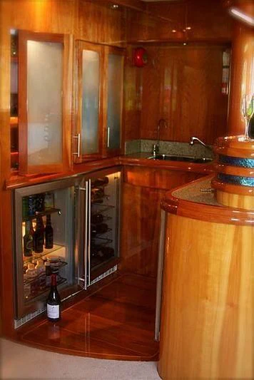 a kitchen with wooden cabinets aboard AZURE II Yacht for Sale