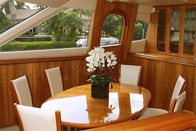 a table with chairs and a plant on it aboard AZURE II Yacht for Sale