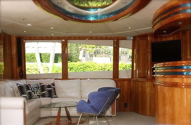 a living room with a couch and a large window aboard AZURE II Yacht for Sale