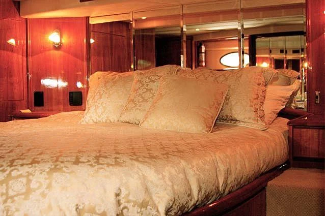 a bed with a white comforter aboard AZURE II Yacht for Sale