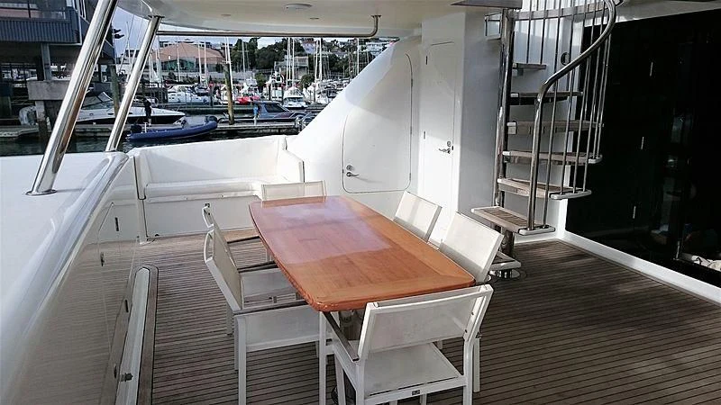 a table and chairs on a deck aboard AZURE II Yacht for Sale