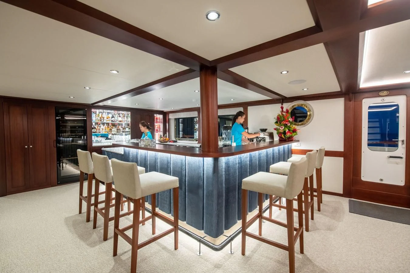 a kitchen with a bar and stools aboard LATITUDE Yacht for Sale