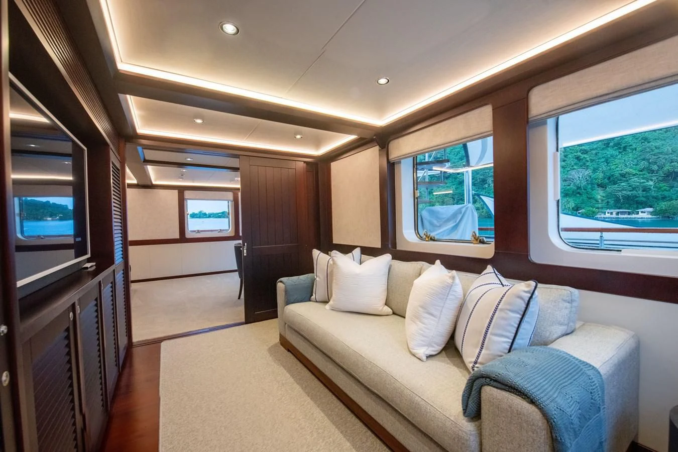 a large room with a couch and a window aboard LATITUDE Yacht for Sale