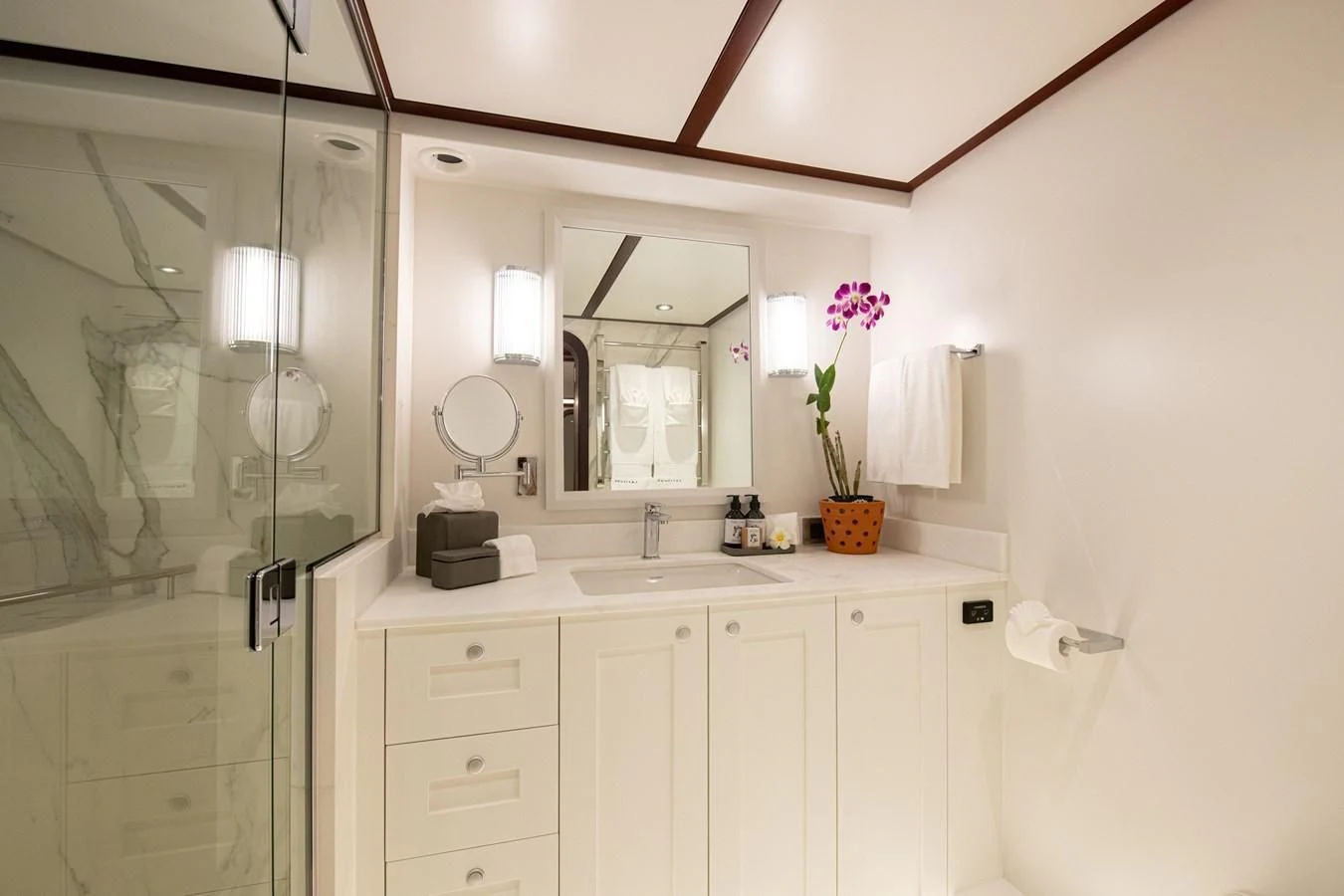a bathroom with a glass shower aboard LATITUDE Yacht for Sale