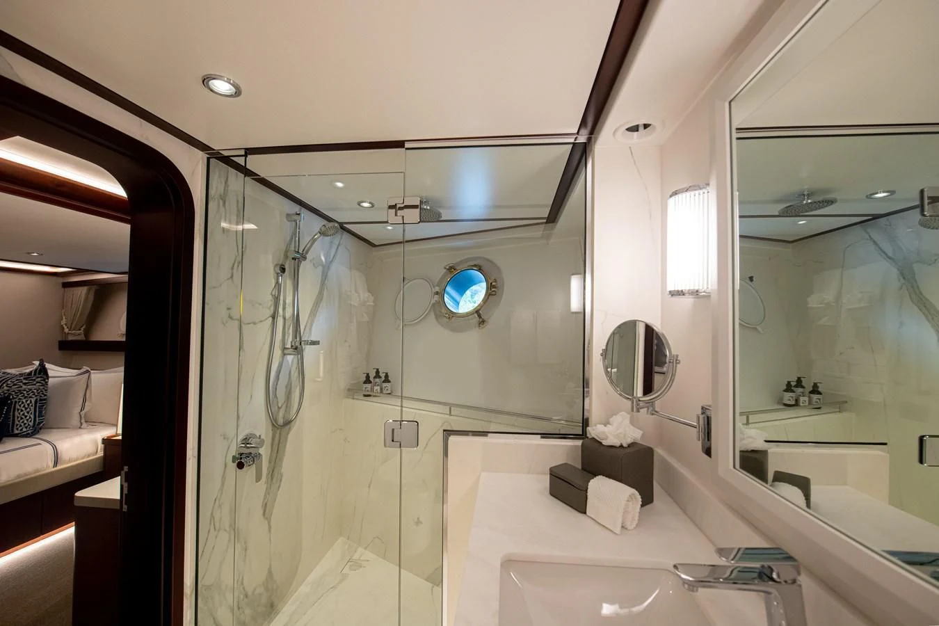 a bathroom with a shower and sinks aboard LATITUDE Yacht for Sale