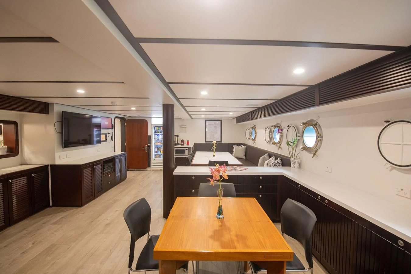 a room with a table and chairs aboard LATITUDE Yacht for Sale