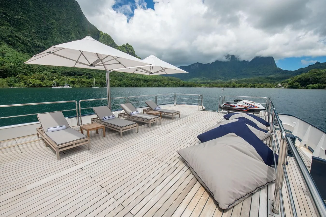 a deck with lounge chairs and umbrellas on it aboard LATITUDE Yacht for Sale