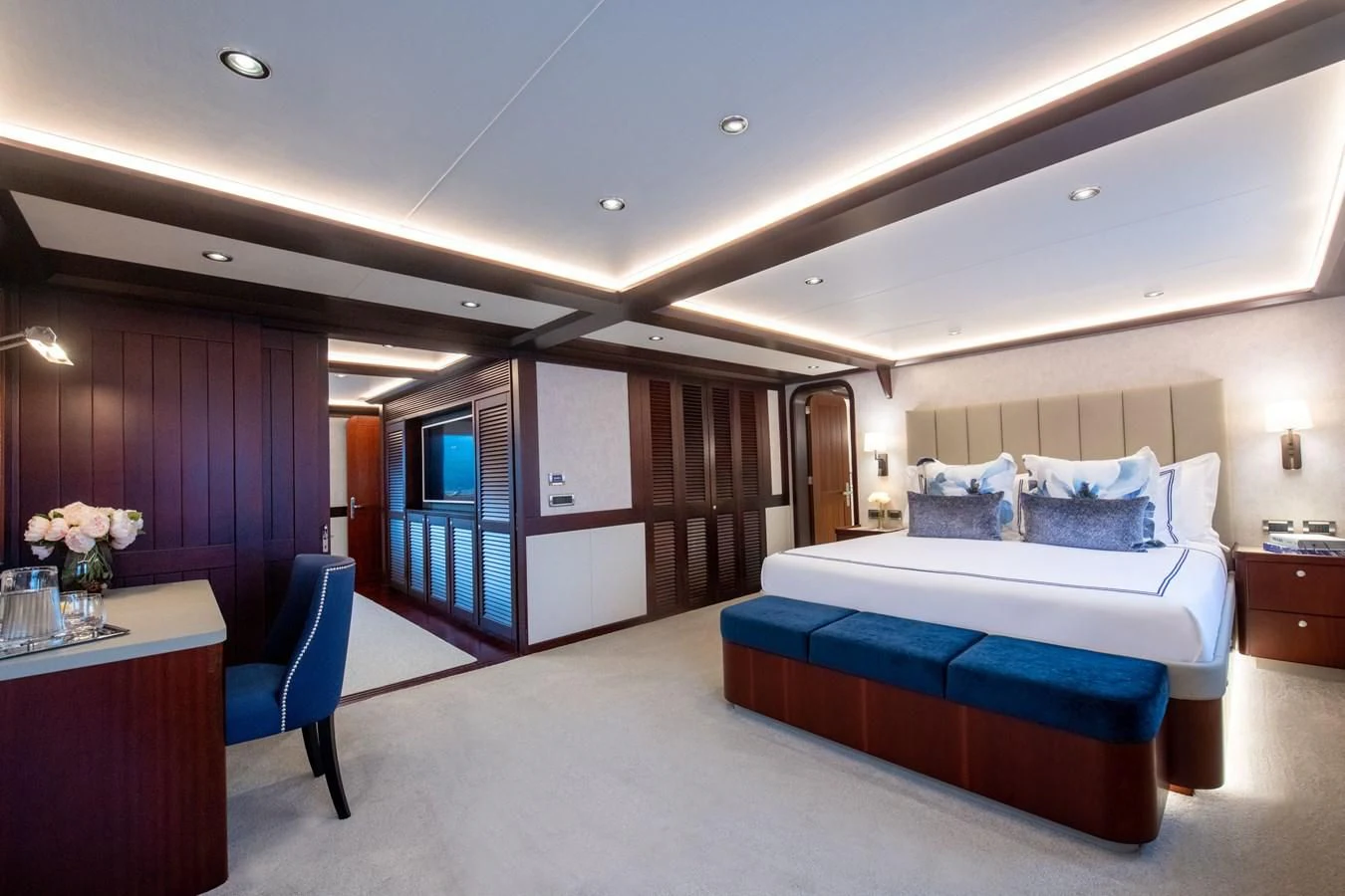 a bedroom with a bed and desk aboard LATITUDE Yacht for Sale