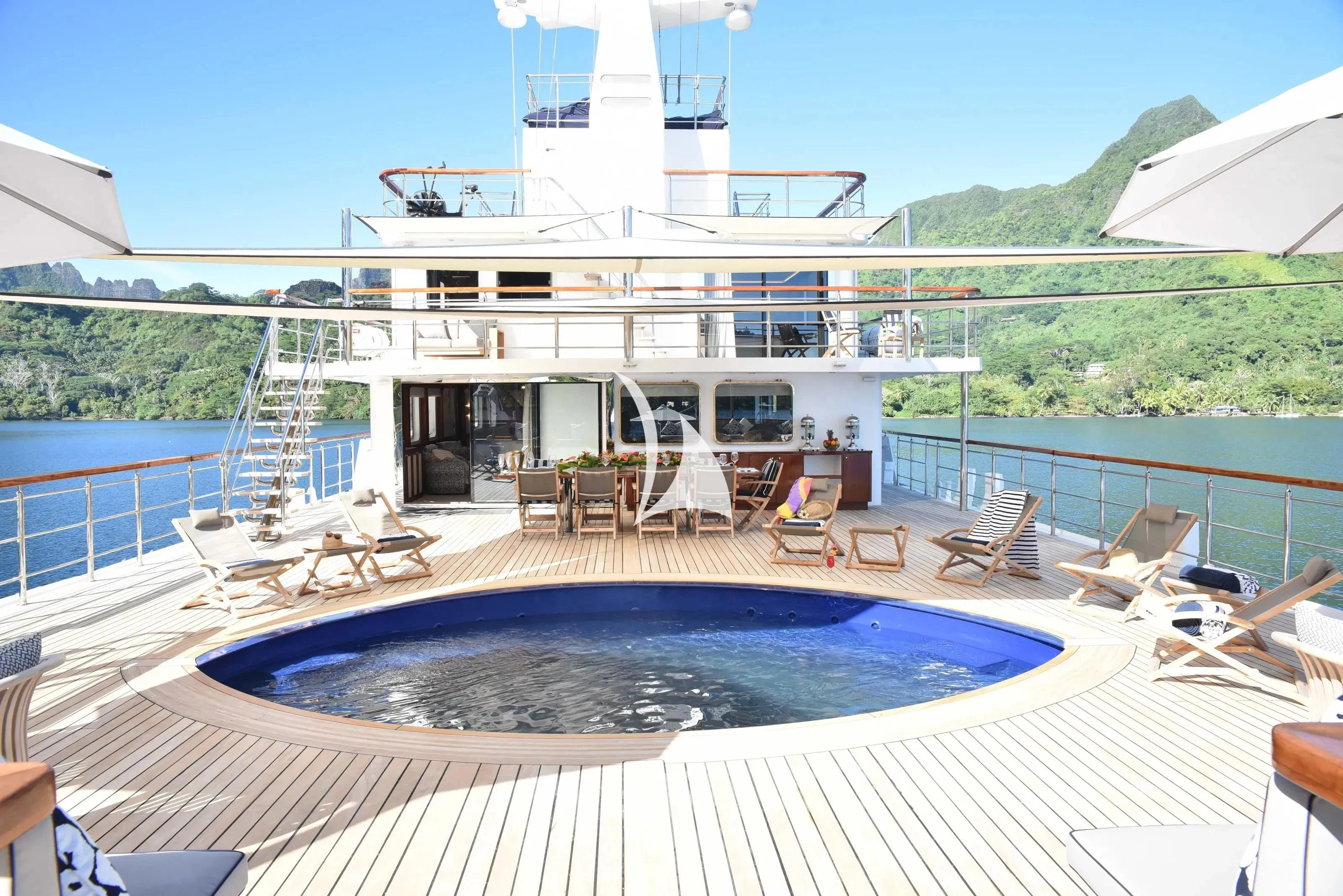 a large white boat on a body of water aboard LATITUDE Yacht for Sale
