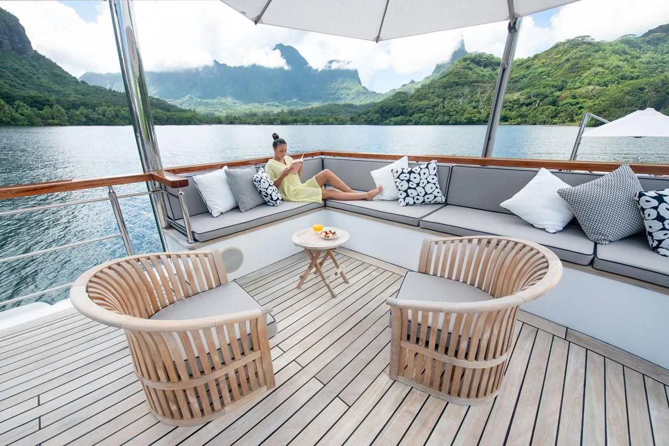 a person sitting on a couch on a boat aboard LATITUDE Yacht for Sale
