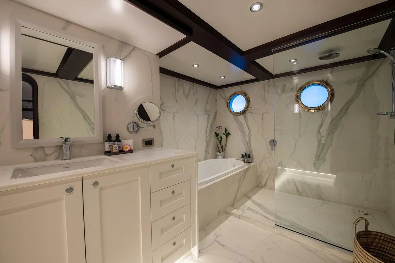 a bathroom with a tub sink and a mirror aboard LATITUDE Yacht for Sale