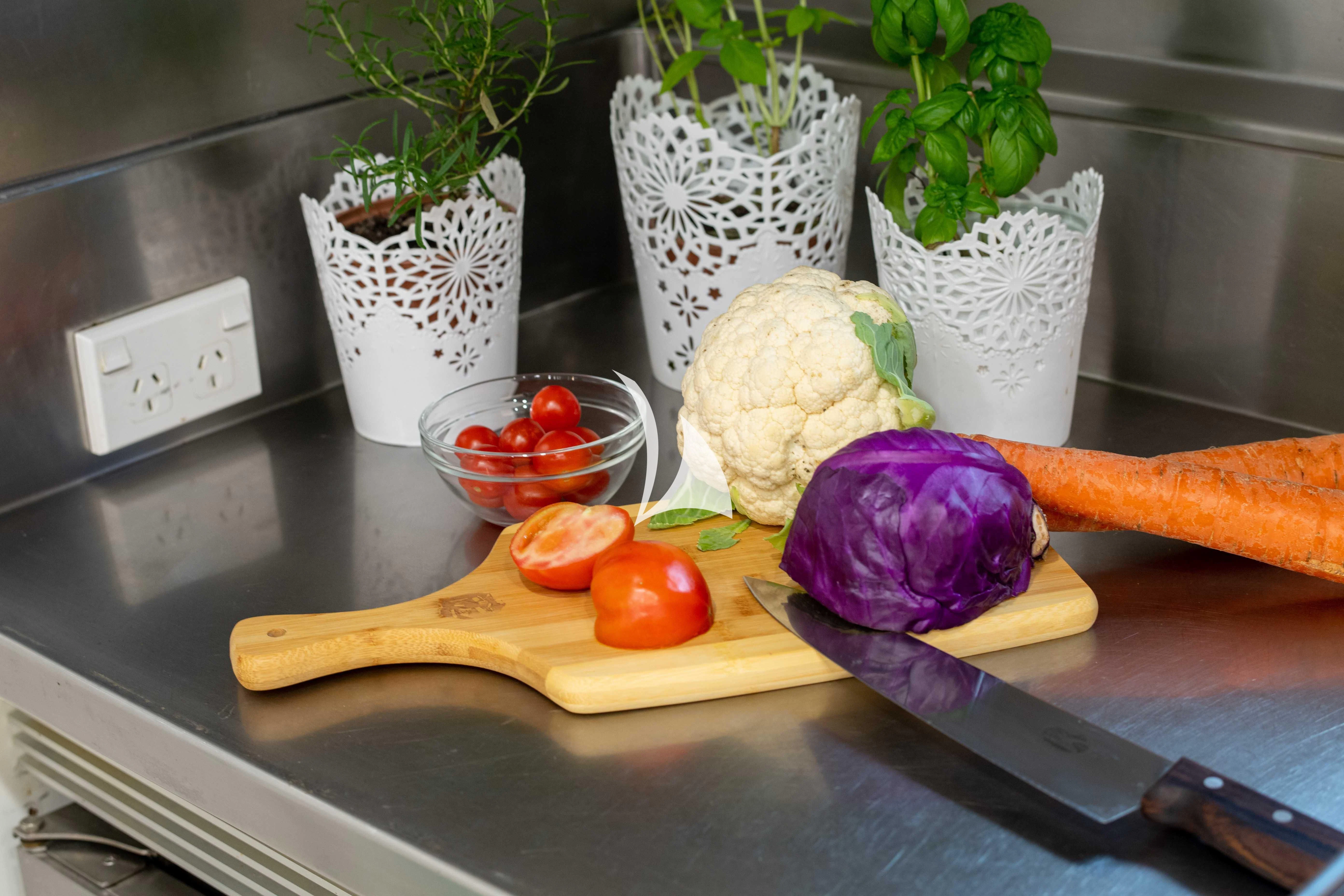 a cutting board with vegetables and fruits aboard LATITUDE Yacht for Sale