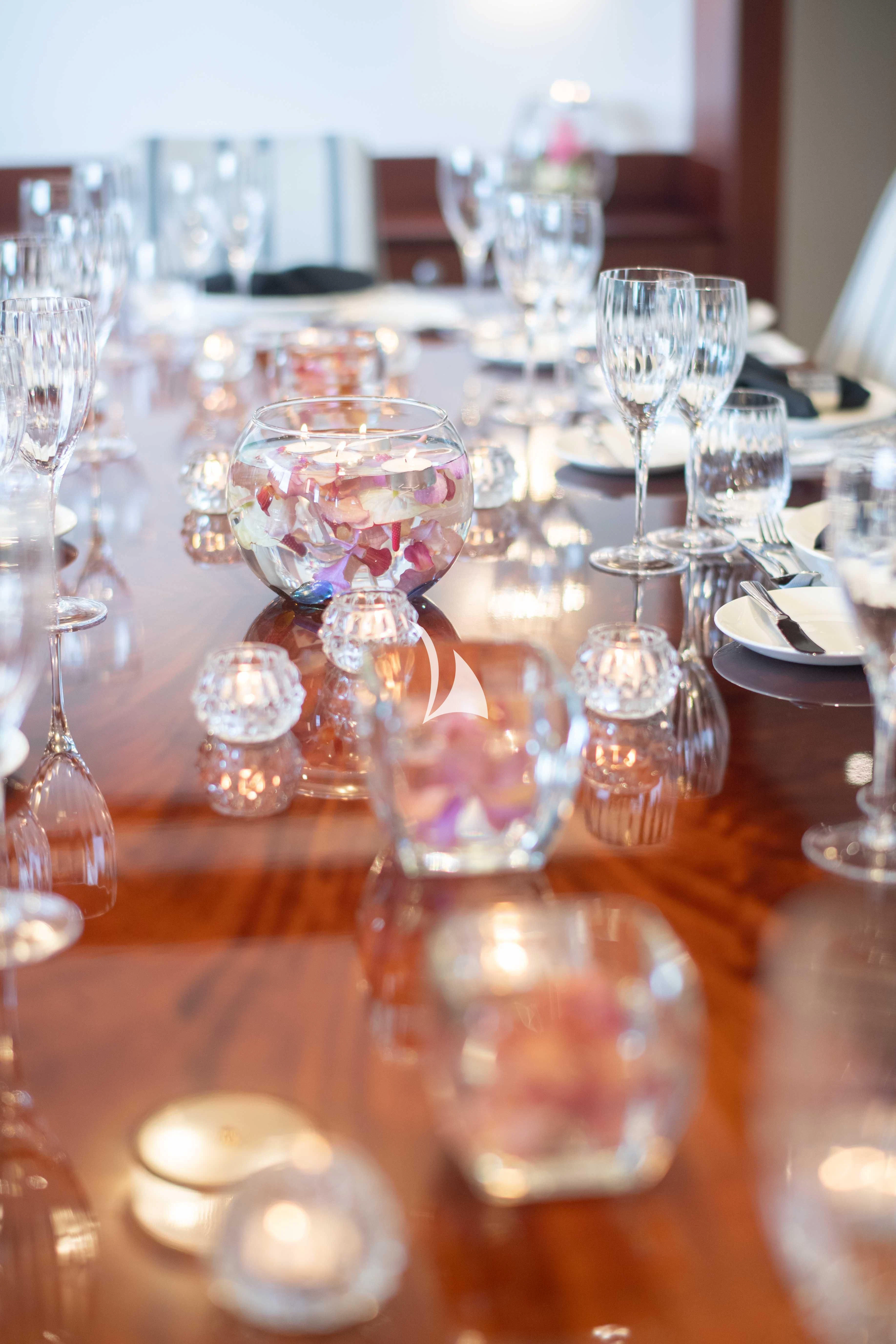 a table with many glasses and plates aboard LATITUDE Yacht for Sale