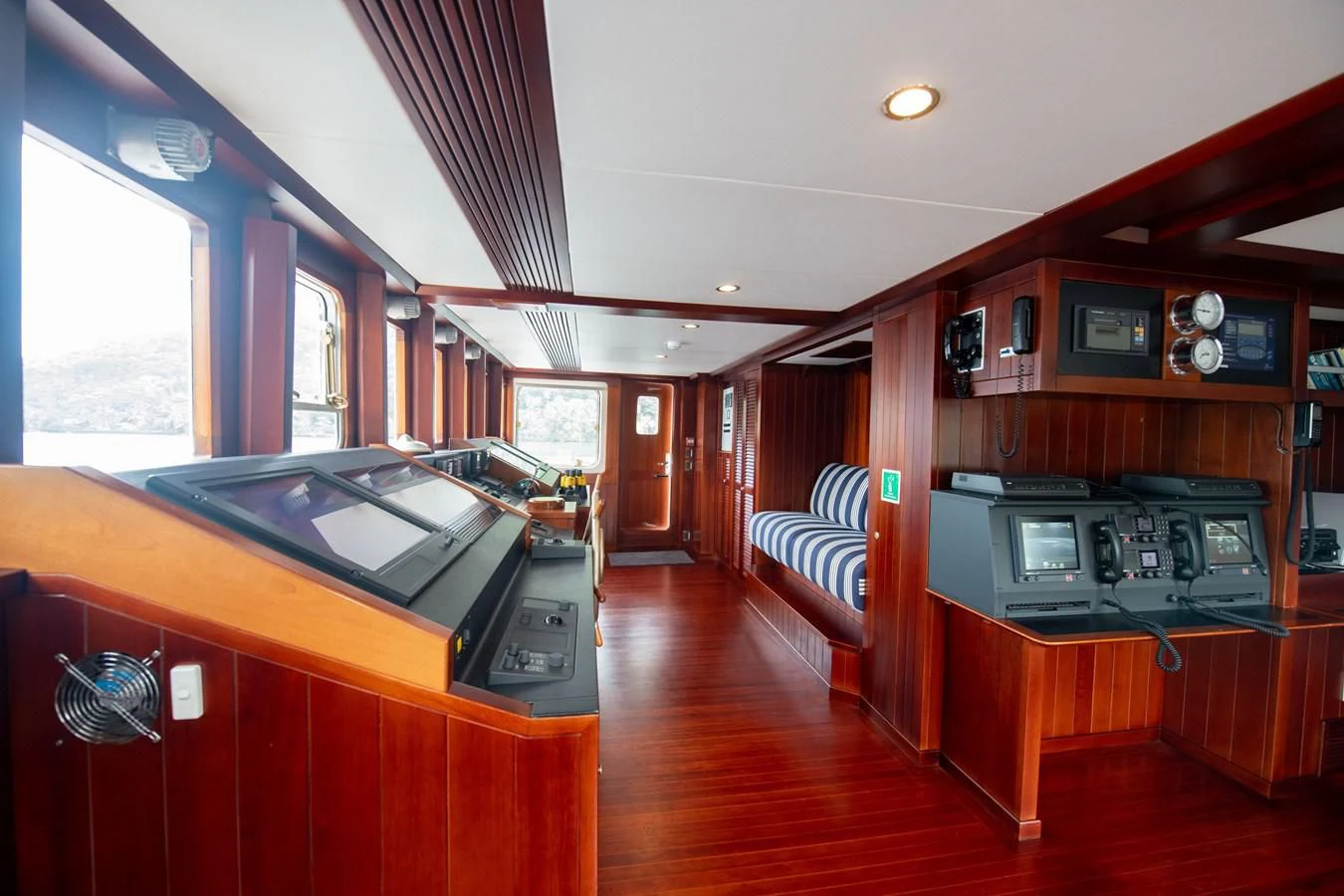 a room with a large desk and a large window aboard LATITUDE Yacht for Sale