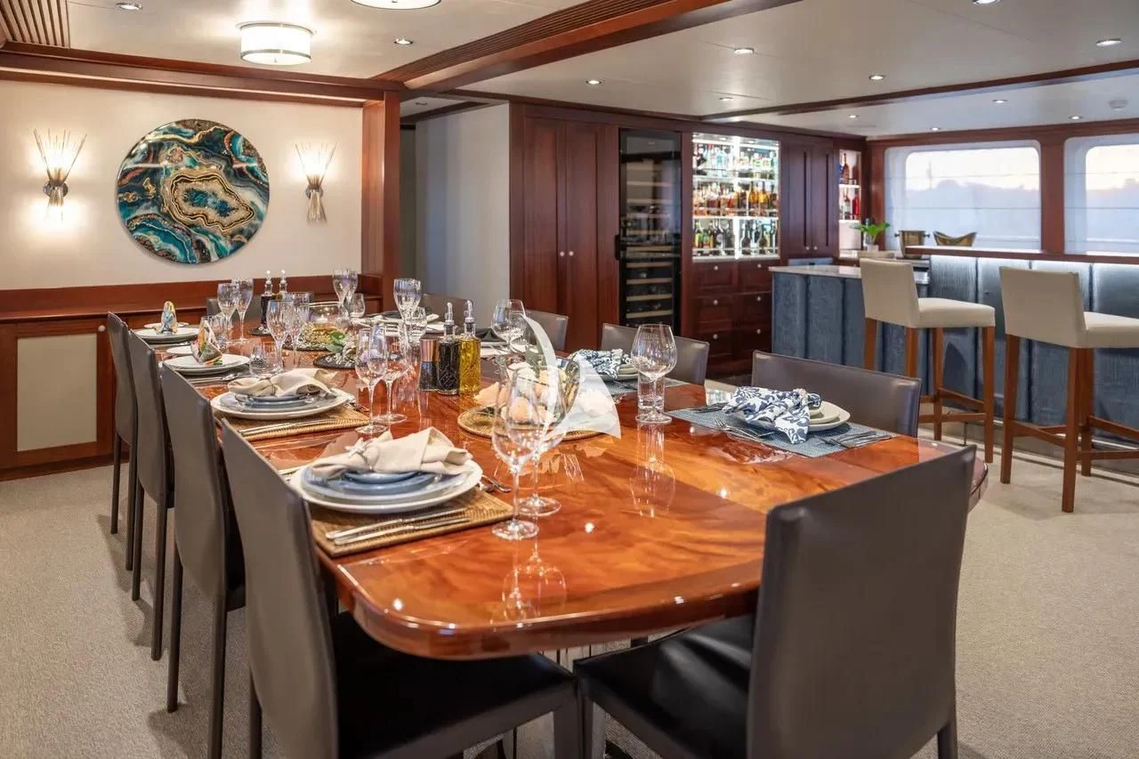a dining room with a table set for a meal aboard LATITUDE Yacht for Sale