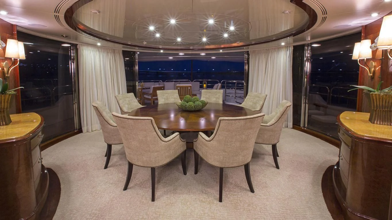 a dining room with a table and chairs aboard DOMANI Yacht for Sale