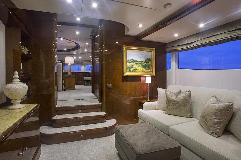 a living room with a large mirror aboard DOMANI Yacht for Sale