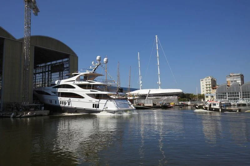 a boat docked at a pier aboard DOMANI Yacht for Sale