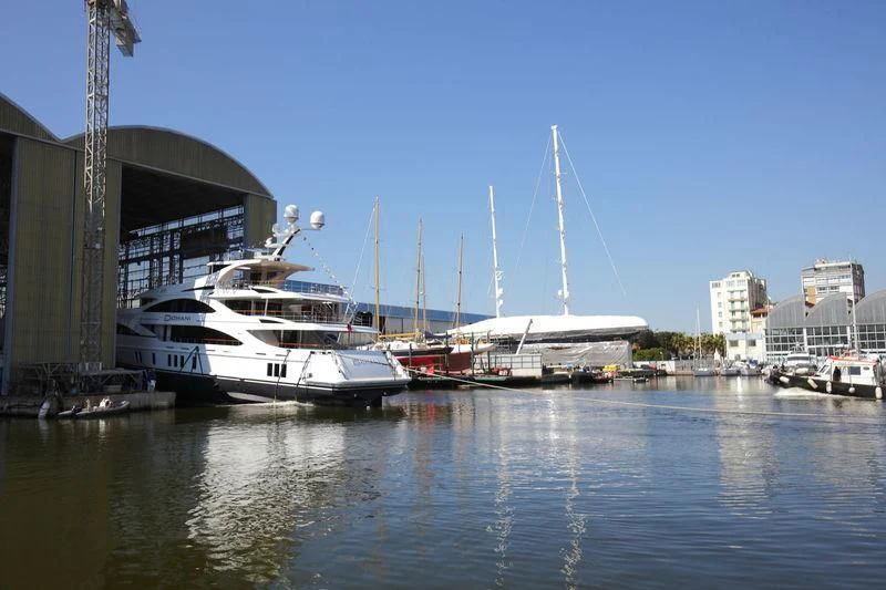 a boat docked at a pier aboard DOMANI Yacht for Sale