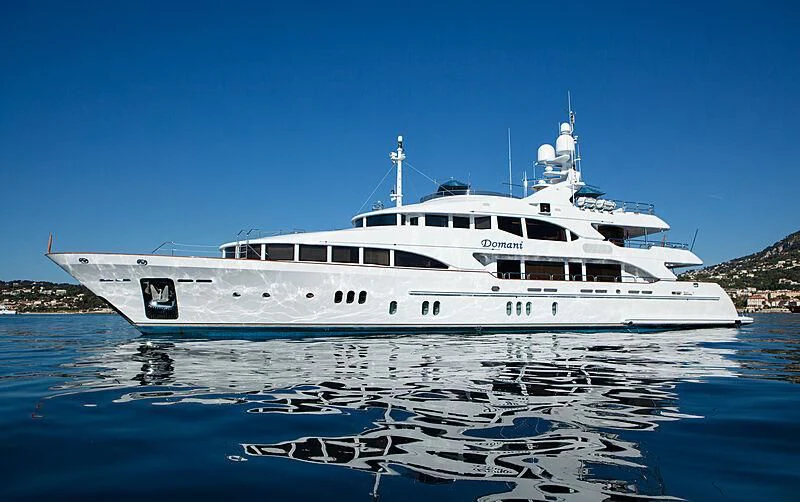 a large white boat in the water aboard DOMANI Yacht for Sale
