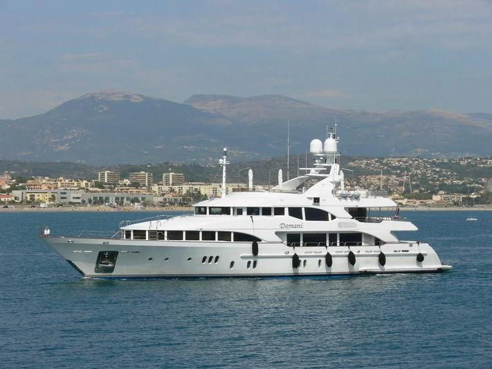 a white yacht in the water aboard DOMANI Yacht for Sale