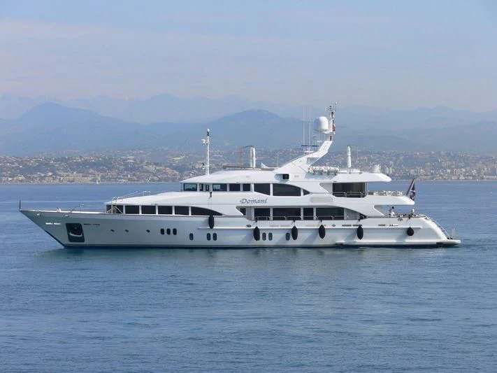 a white yacht in the water aboard DOMANI Yacht for Sale