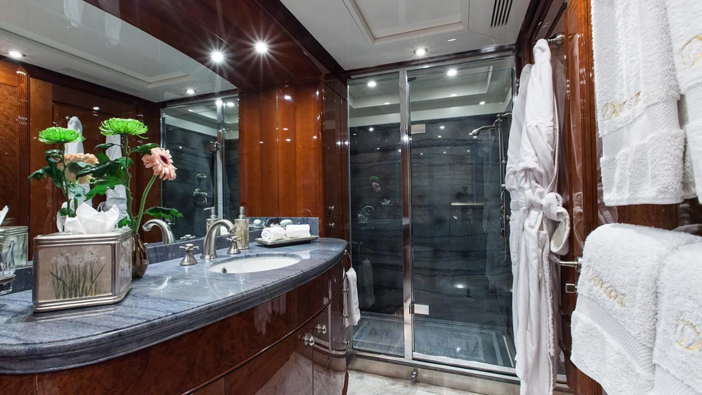 a bathroom with a large glass shower aboard DOMANI Yacht for Sale