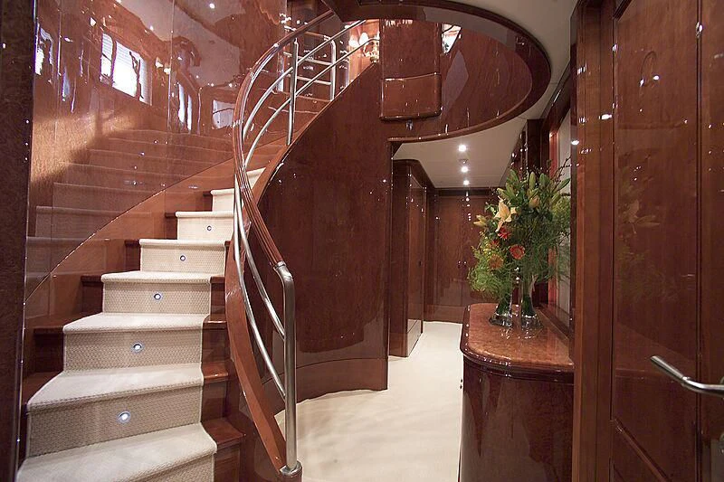 a staircase with a vase of flowers aboard DOMANI Yacht for Sale