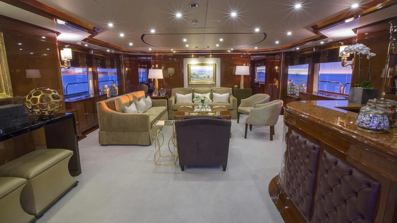 a living room with a large mirror aboard DOMANI Yacht for Sale
