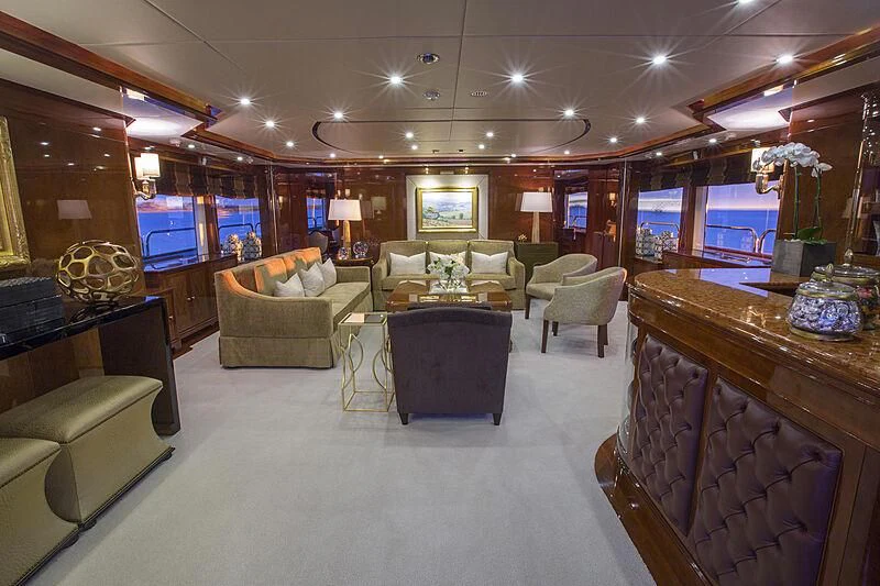 a large living room with a bar and a bar aboard DOMANI Yacht for Sale