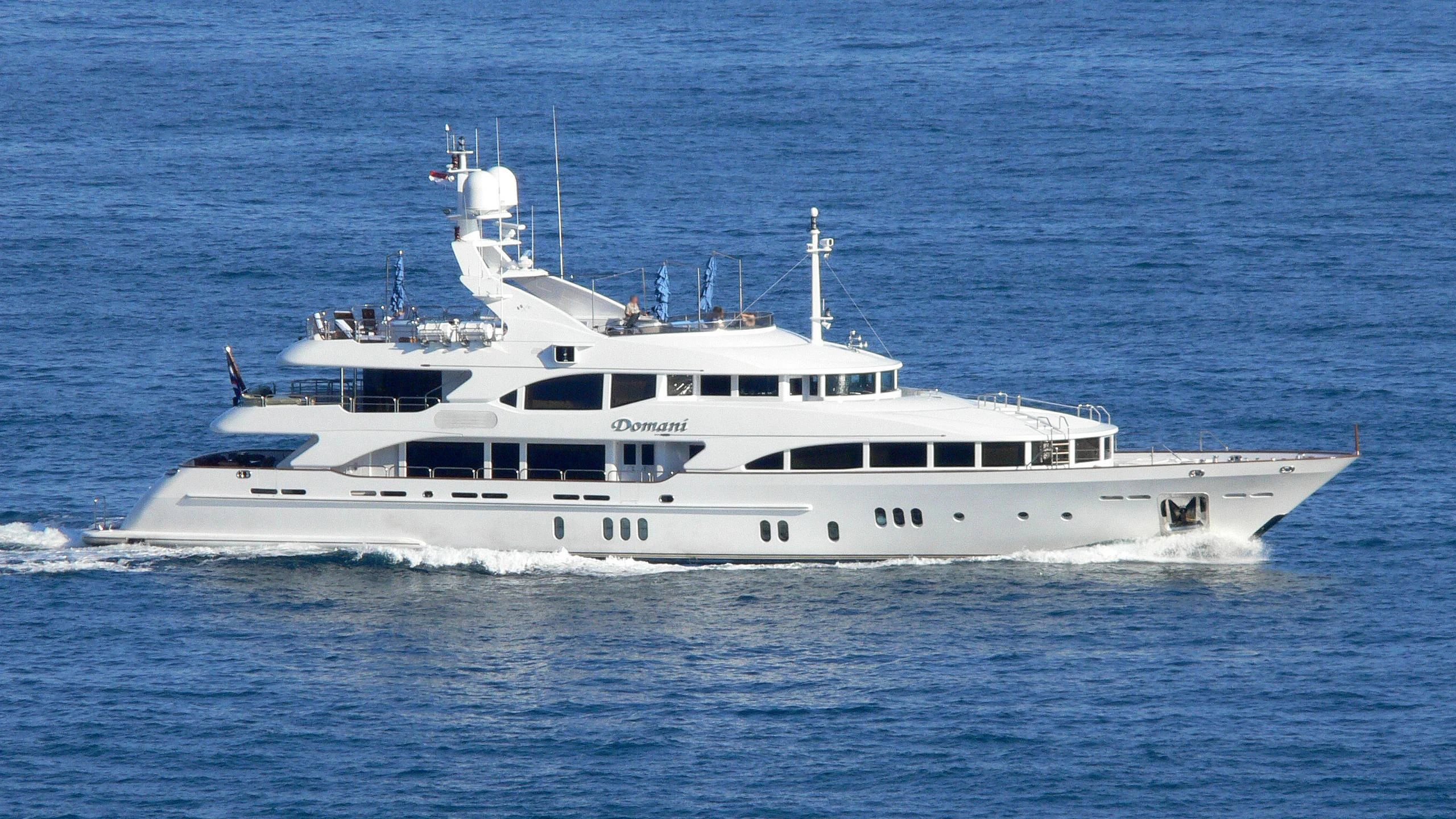 a white yacht in the water aboard DOMANI Yacht for Sale