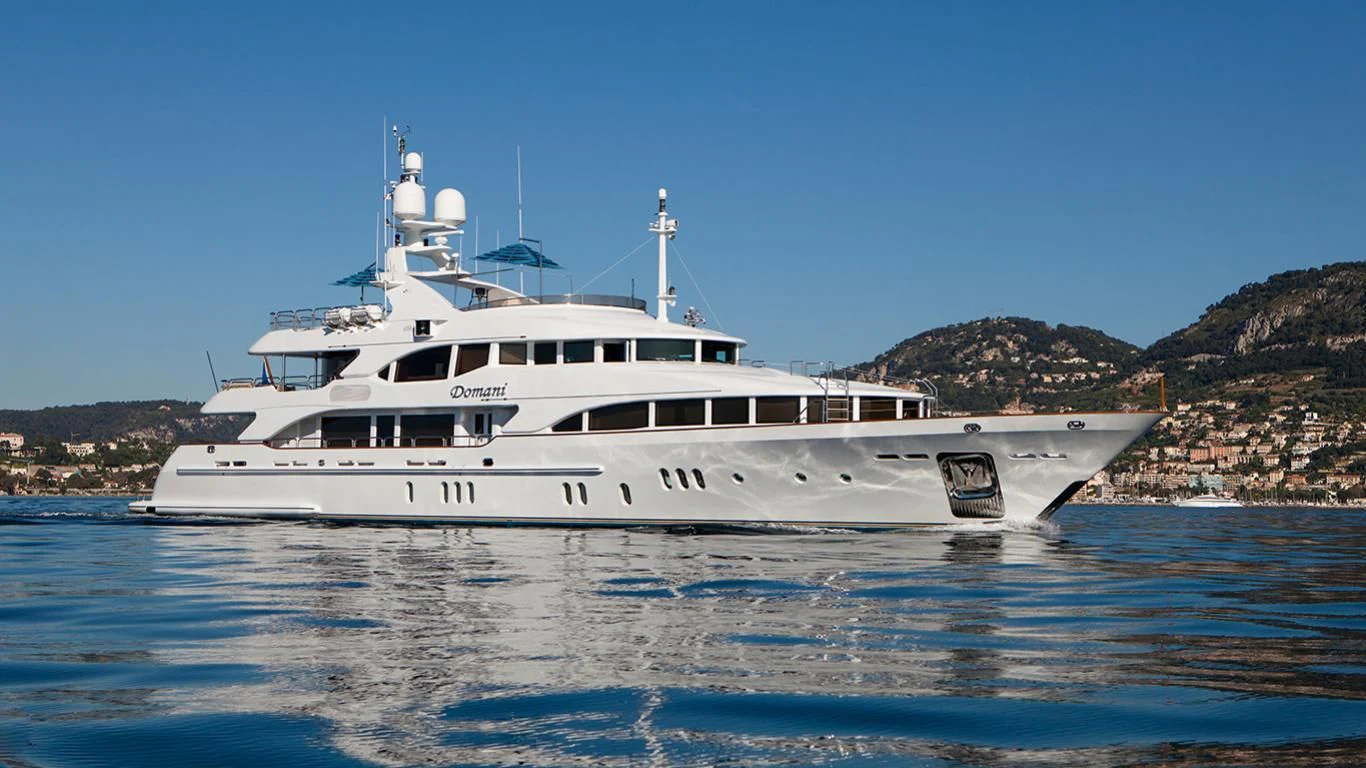 a white yacht in the water aboard DOMANI Yacht for Sale