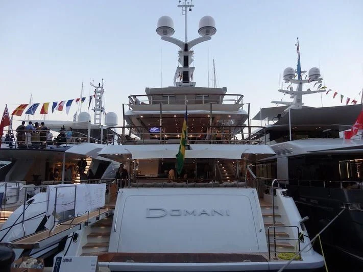 a large ship docked aboard DOMANI Yacht for Sale