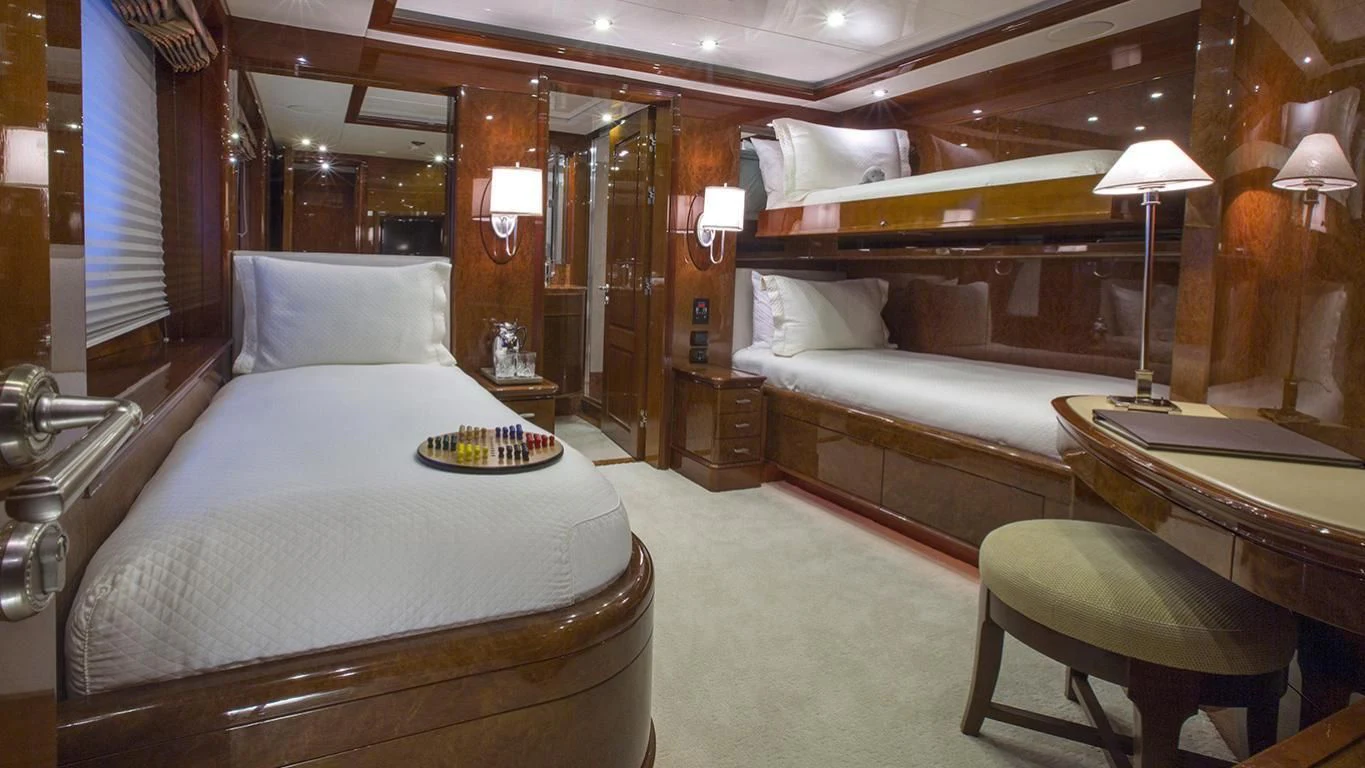 a room with a bed and a desk aboard DOMANI Yacht for Sale