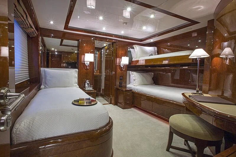 a room with a bed and a desk aboard DOMANI Yacht for Sale